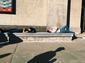Students laying in the sun outside of the College of Fine Arts